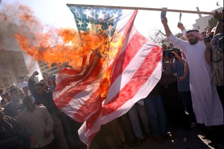 Bahraini protesters torch US flag