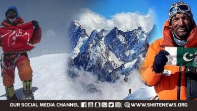 Shia mountaineer M Ali Sadpara raises Pakistani and HUssaini flags at K2