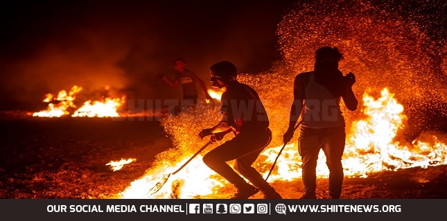 Gazans burn tires near fence for second night to protest Israeli siege