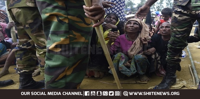 Rohingya refugees wait for food distribution organised by the Bangladesh army at the refugee camp of Balukhali near Gumdhum on September 25, 2017.