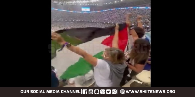 Football fans raise Palestine flag at FIFA World Cup during Argentina vs France match